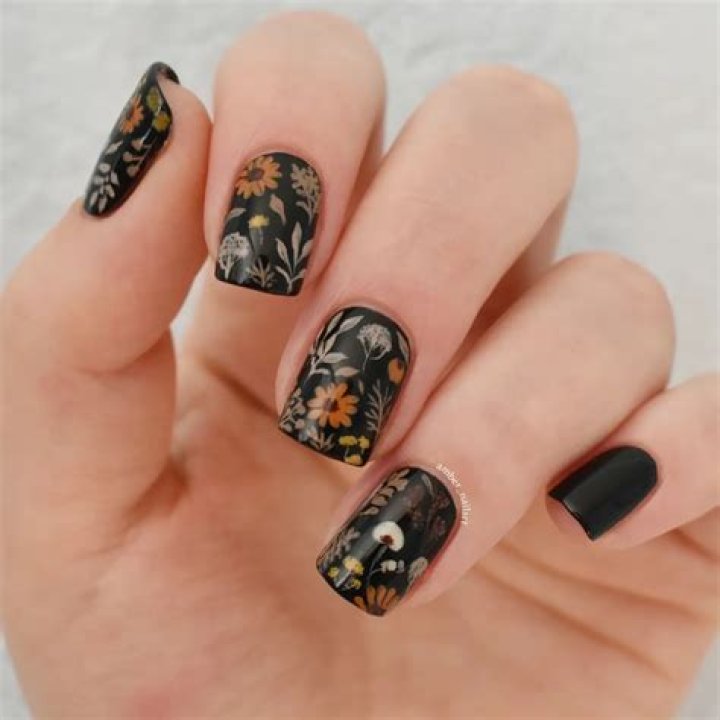 Dark moody botanical floral nail art with deep green and burgundy tones